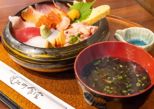 "A delicious seafood bowl filled with fresh sashimi and rice."
