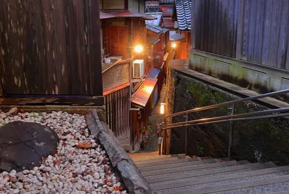 "A narrow, secluded alley in a historic teahouse district, showcasing traditional Japanese architecture and charm."