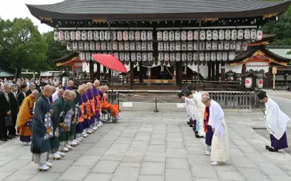 Shinto vs. Buddhism? A Deep Dive into Japan’s 2 Major Religions "A Shinto priest and a Buddhist monk bowing respectfully during a traditional Japanese religious ceremony, demonstrating reverence and humility in their practices."