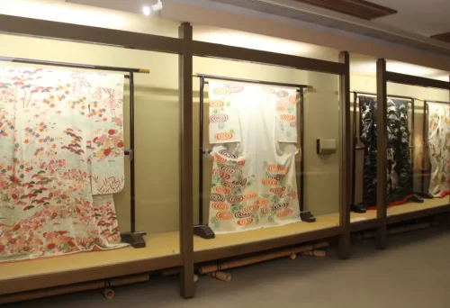 "Exquisite Kaga Yuzen kimonos on display at Kaga Yuzen Hall in Kanazawa, showcasing traditional Japanese dyeing techniques and vibrant designs."