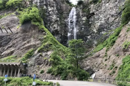 Scenic waterfall cascading down the rocky cliffs along the Hakusan–Shirakawa-go White Road in Ishikawa, Japan.