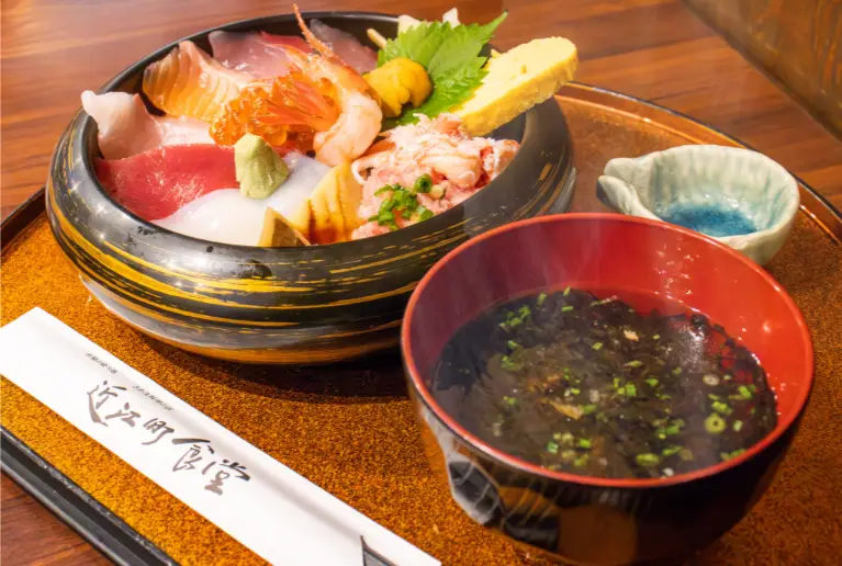 Local dishes of Kanazawa featuring fresh seafood bowl and regional specialties at Omicho Market.