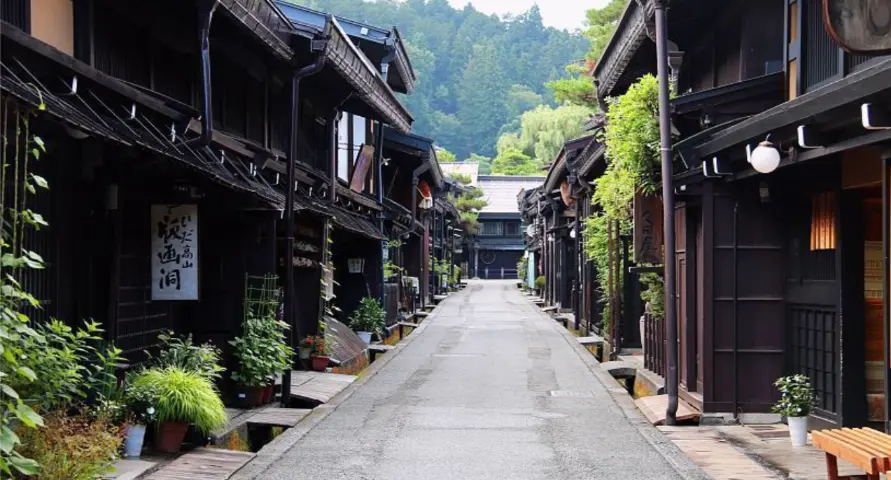 Peaceful street lined with traditional wooden houses in Takayama’s old town district.