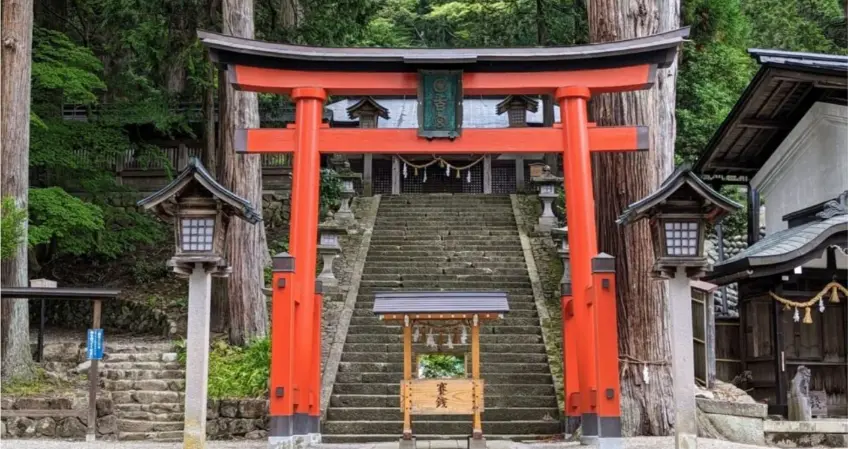 Traveler showing respect and gratitude at a local shrine in Takayama