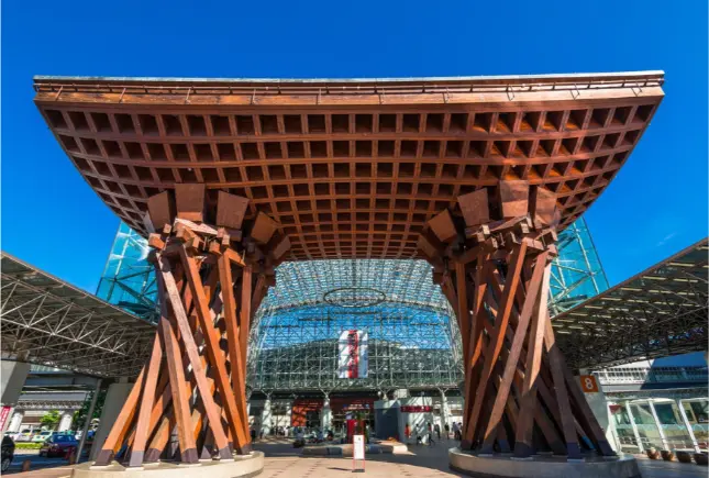 Travelers departing from Kanazawa Station’s iconic Tsuzumi Gate toward Noto Peninsula