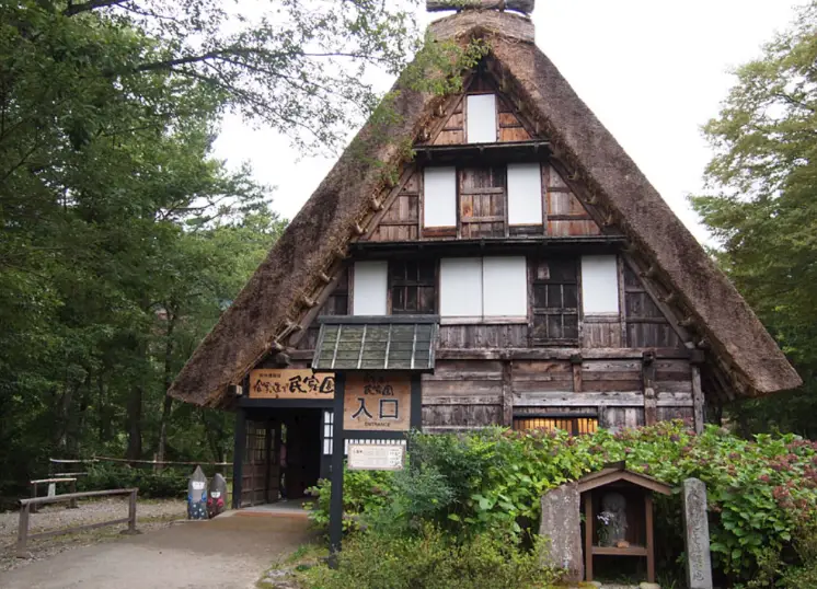 The main entrance of the Shirakawa-go Gassho-zukuri Folk Museum, showing a traditional thatched-roof house used as the museum building.