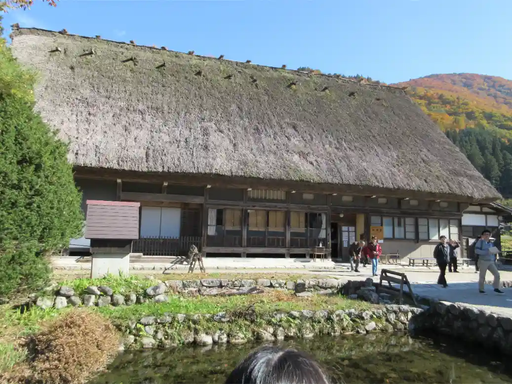 The thatched-roof exterior of Wada House in Shirakawa-go, showcasing the largest and most prominent gasshō-zukuri residence in the village.