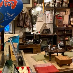 Traditional Japanese living room from the Showa era, featuring a low table, vintage household items, and retro décor inside the Takayama Showa Museum.